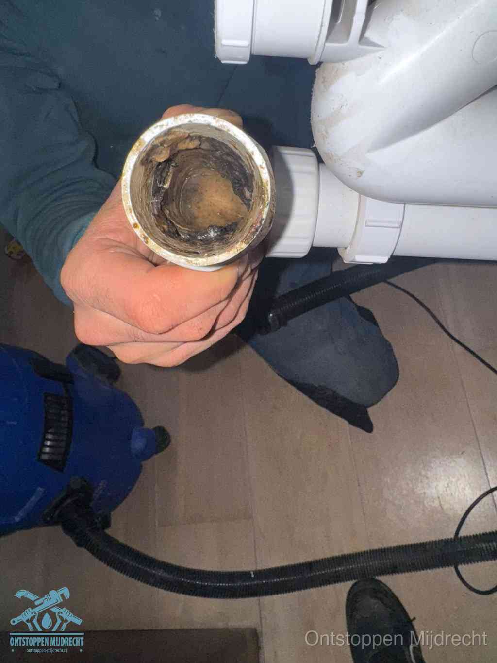 Een losgekoppeld afvoerbuisstuk dat van binnen volledig is dichtgeslibd, het gevolg van een verstopping te lang laten zitten in Mijdrecht